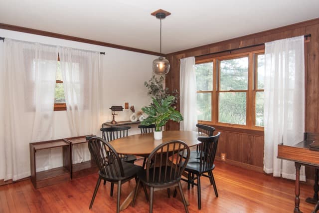 Bright dining area with warm wood accents and large windows, perfect for shared meals and relaxing gatherings.