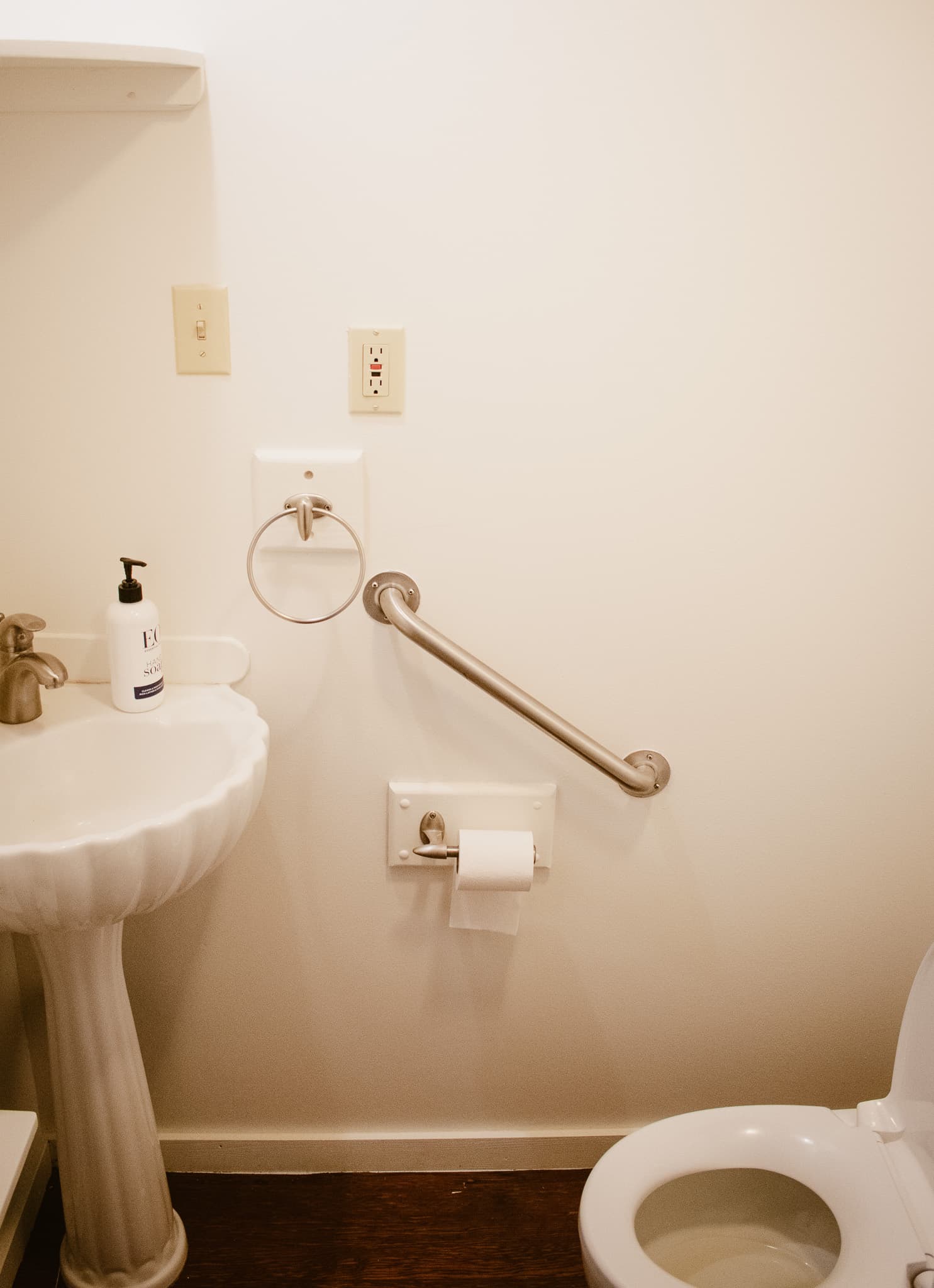 Clean and comfortable bathroom with modern amenities, accessible features, and bright coastal inspired design.