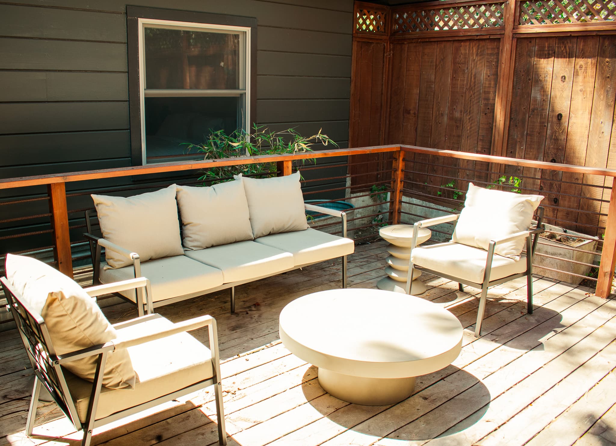 Private outdoor patio with comfortable lounge seating, peaceful surroundings, and space to relax and unwind.