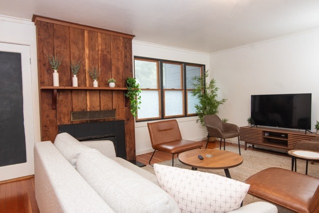 Cozy living room with a comfortable sofa, dedicated workspace, and bright dining area. Perfect for relaxing coastal getaways and remote work stays.