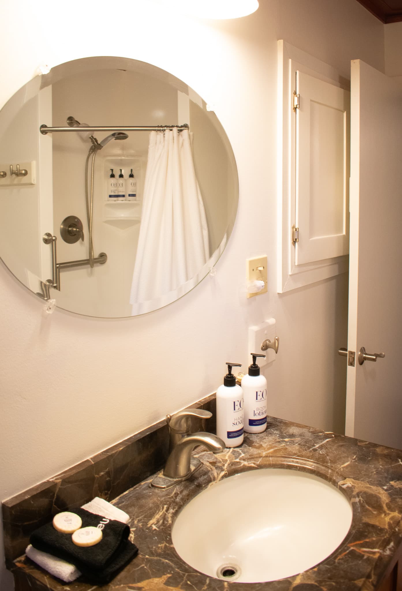 Modern bathroom featuring a marble vanity, walk-in shower, and clean contemporary finishes for a comfortable stay.