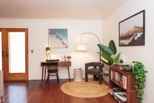 Cozy reading and workspace nook with stylish decor, warm lighting, and modern comforts. Perfect for relaxing stays and remote work.